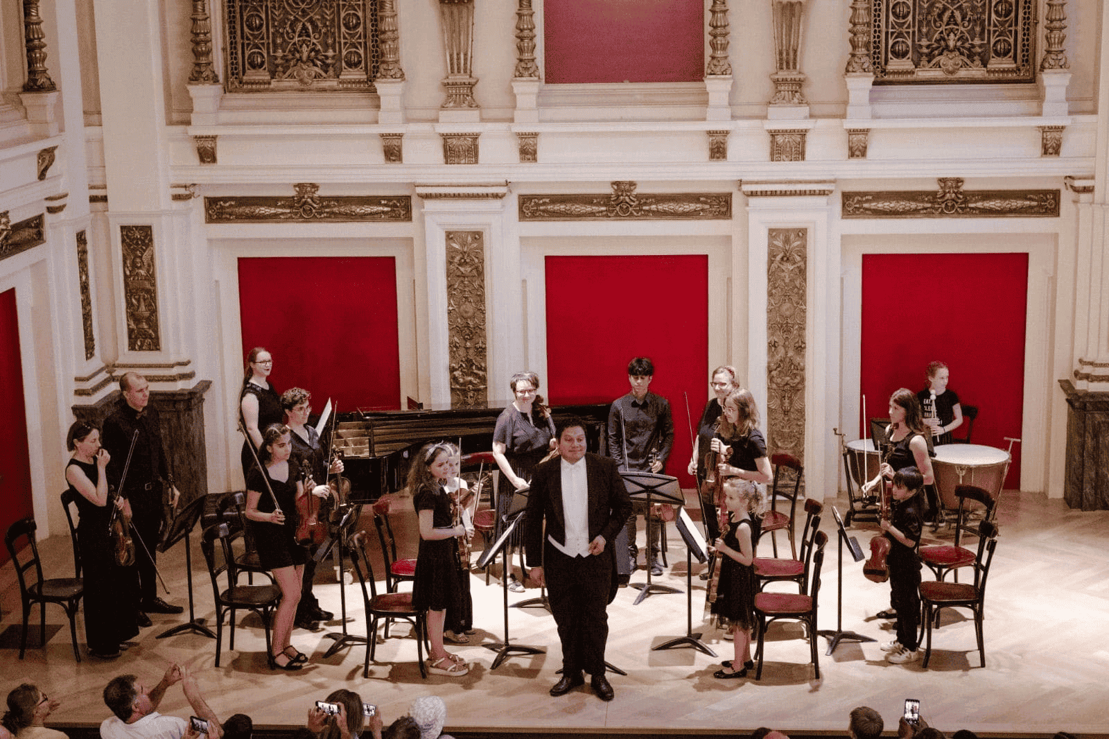 Young students performing classical music concert at Vienna Concert Hall, promoting El Sistema Austria music education program.